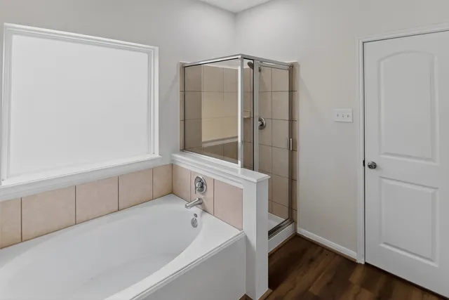 a bathroom with a bathtub and a shower