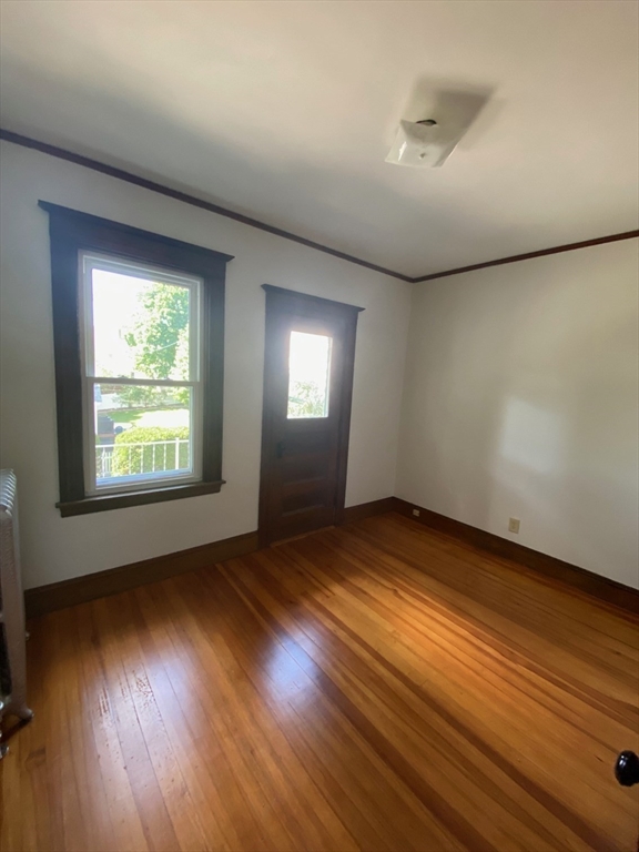 14 Welton Road Boston, MA 02132 - Photo 25 of 31 an empty room with wooden floor and windows