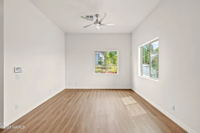 a view of an empty room with wooden floor