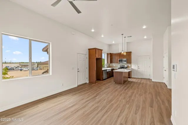 a kitchen with stainless steel appliances granite countertop a sink a stove and a refrigerator