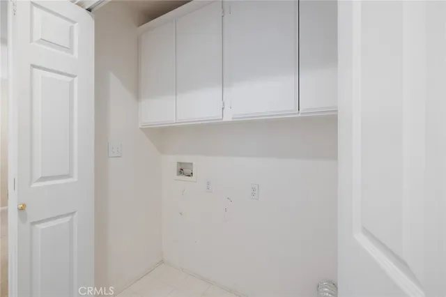 an empty room with windows and bathroom