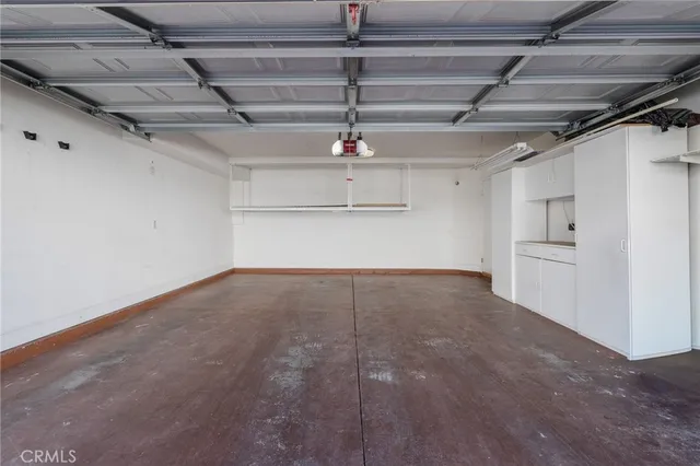 front view of a house with a yard and potted plants