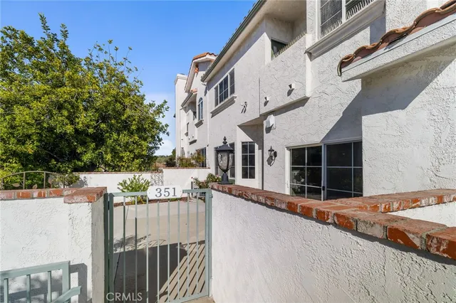 a view of a house with a flower garden