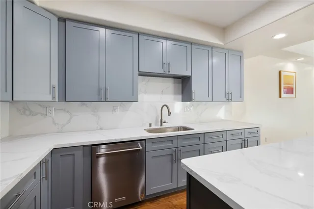 a kitchen with a sink cabinets and stainless steel appliances