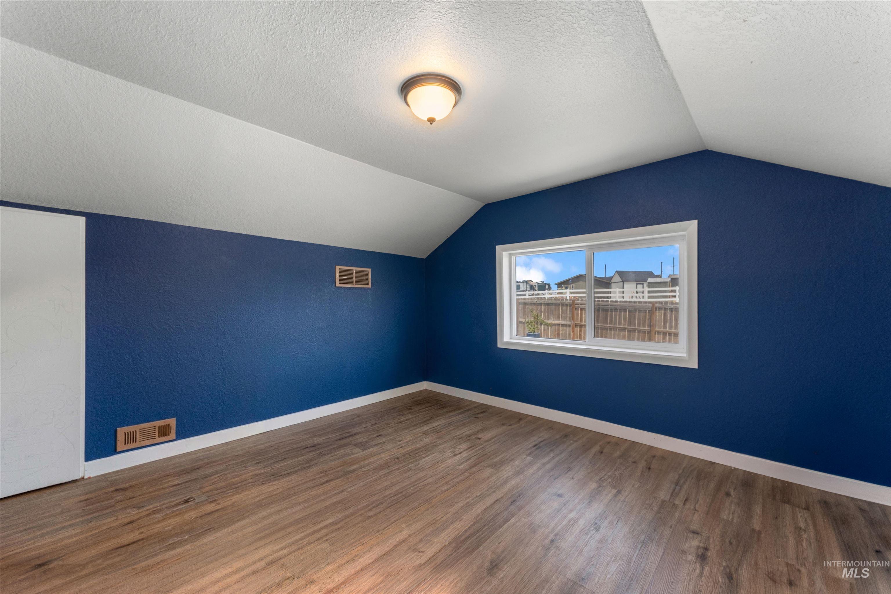 17441 Upper Pleasant Ridge Road Caldwell, ID 83607 - Photo 15 of 40 Room with vaulted ceilings and wood-finish flooring