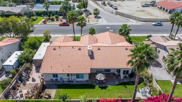 an aerial view of a house with garden space and street view