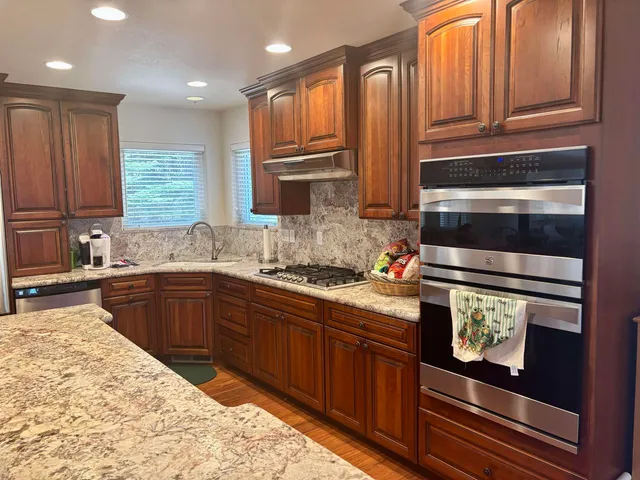 a bedroom with a bed and a lamp on dresser