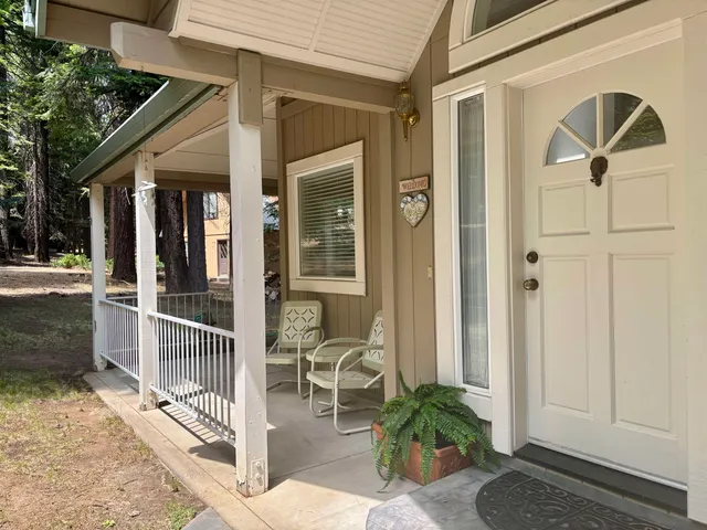 a living room with furniture wooden floor and window