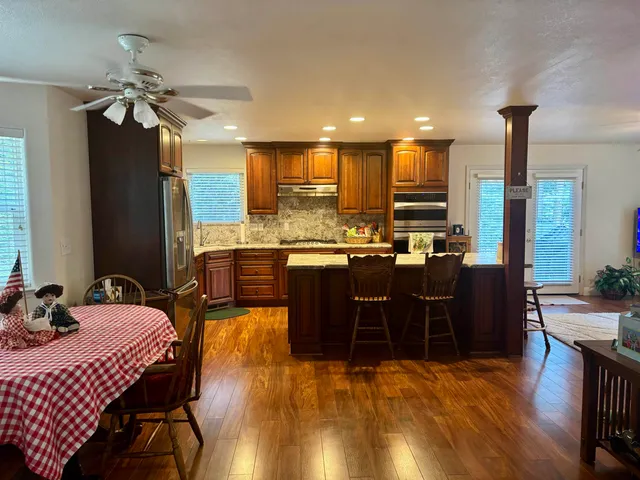 a kitchen with stainless steel appliances granite countertop a refrigerator sink and cabinets