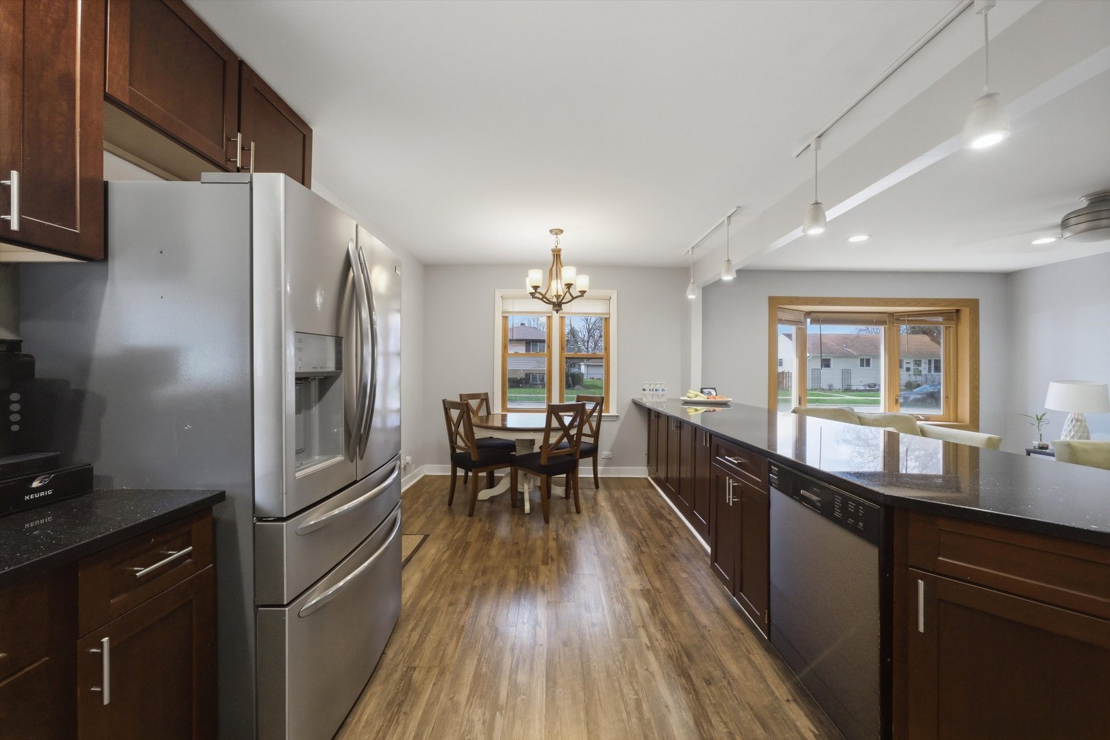 3841 Arthur Avenue Brookfield, IL 60513 - Photo 11 of 34 a kitchen with stainless steel appliances granite countertop a refrigerator a sink dishwasher a stove and white countertops with wooden floor