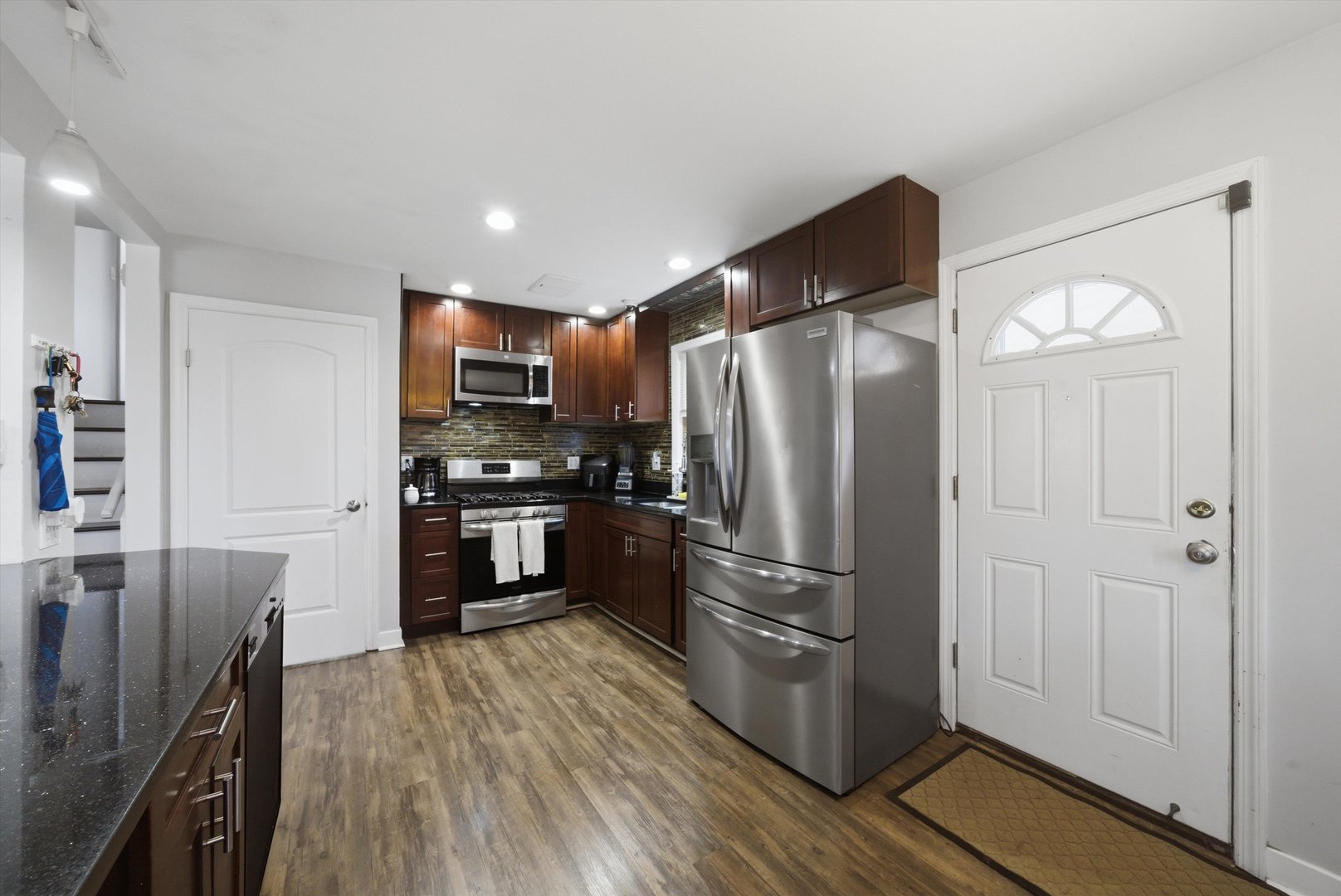 3841 Arthur Avenue Brookfield, IL 60513 - Photo 12 of 34 a kitchen with granite countertop stainless steel appliances a refrigerator cabinets and wooden floor