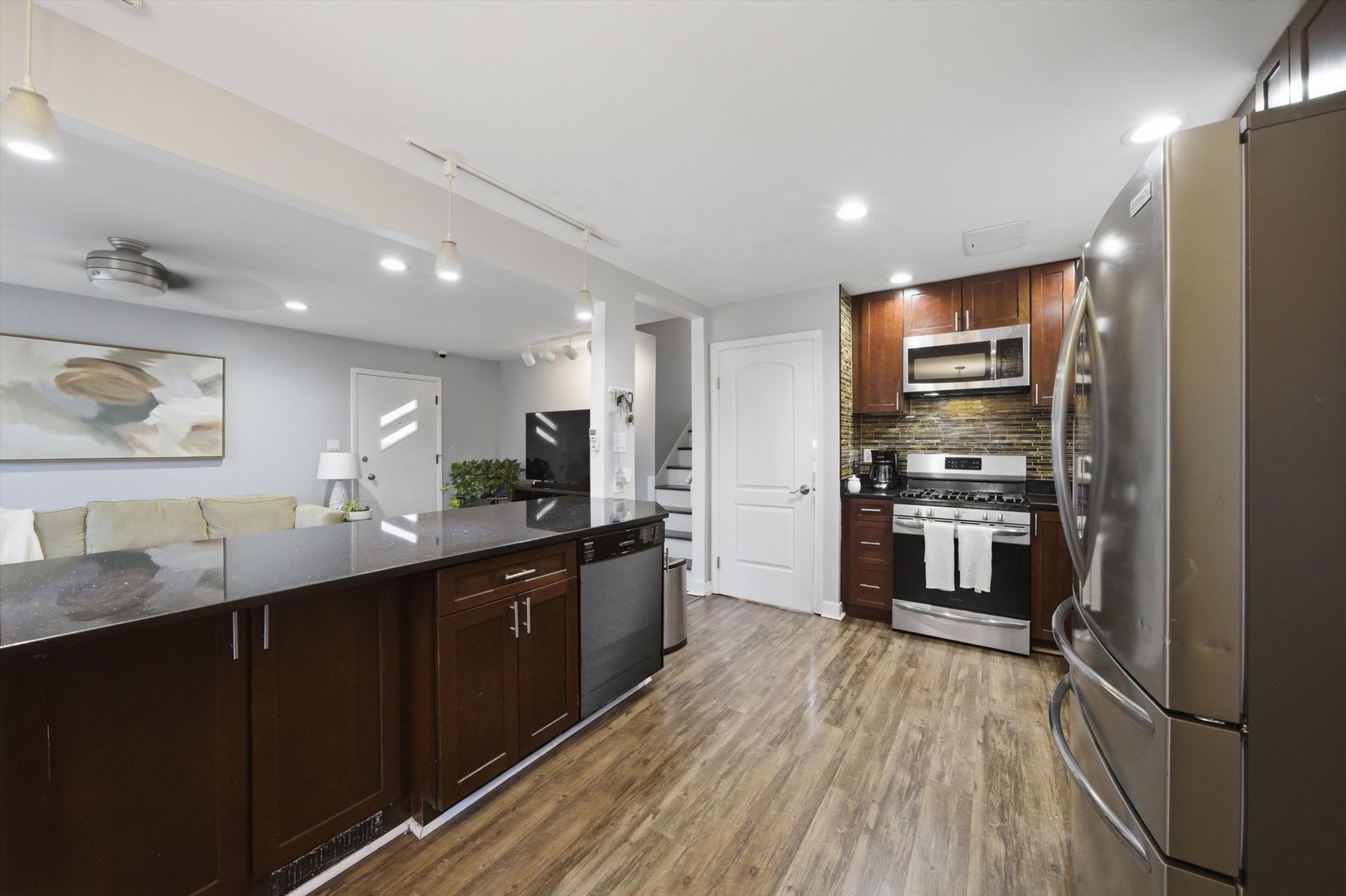 3841 Arthur Avenue Brookfield, IL 60513 - Photo 14 of 34 a kitchen with stainless steel appliances kitchen island granite countertop a refrigerator a sink dishwasher and a stove with wooden floor