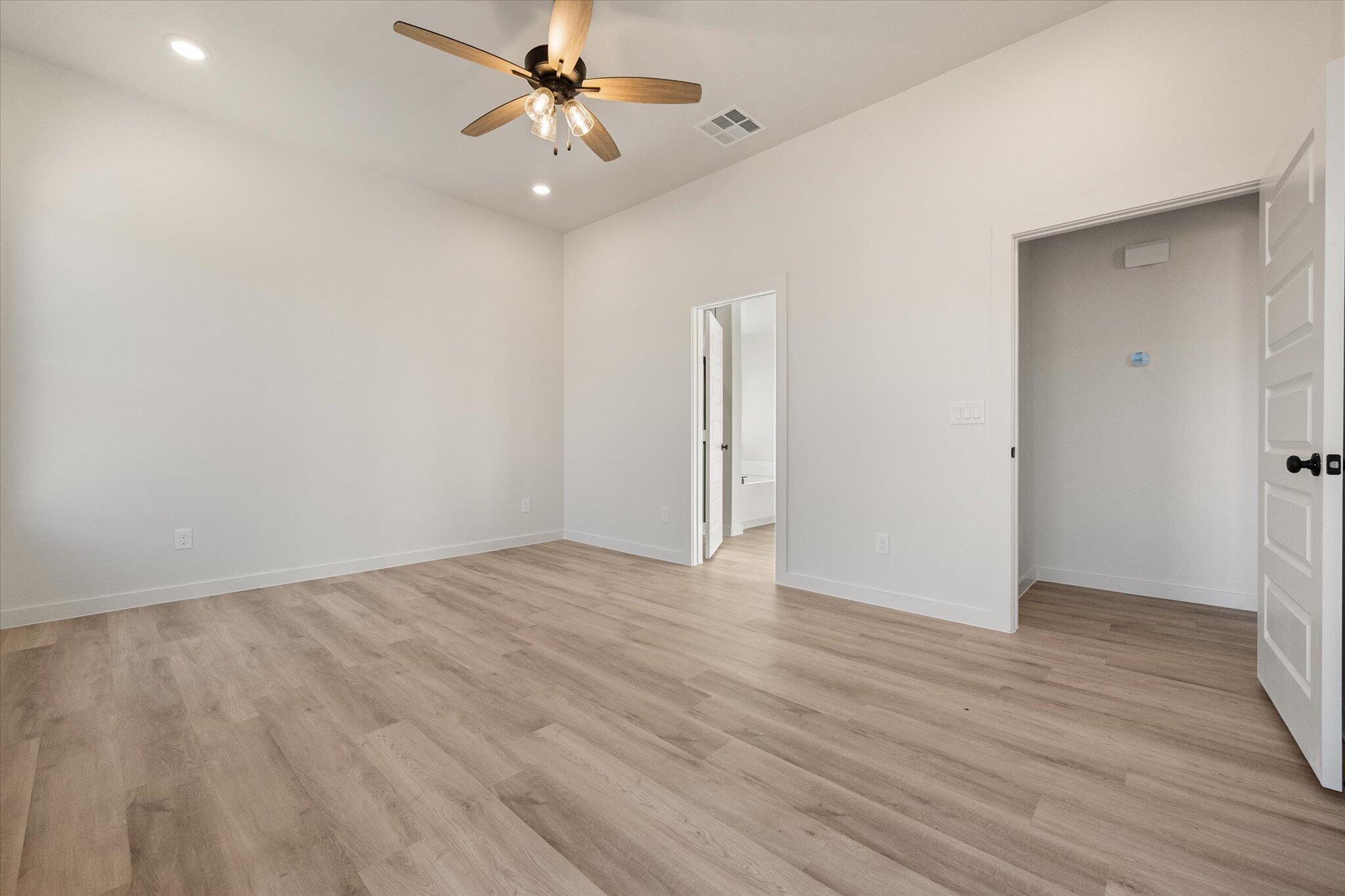 6927 53rd Street Lubbock, TX 79407 - Photo 11 of 21 wooden floor in an empty room with a fan