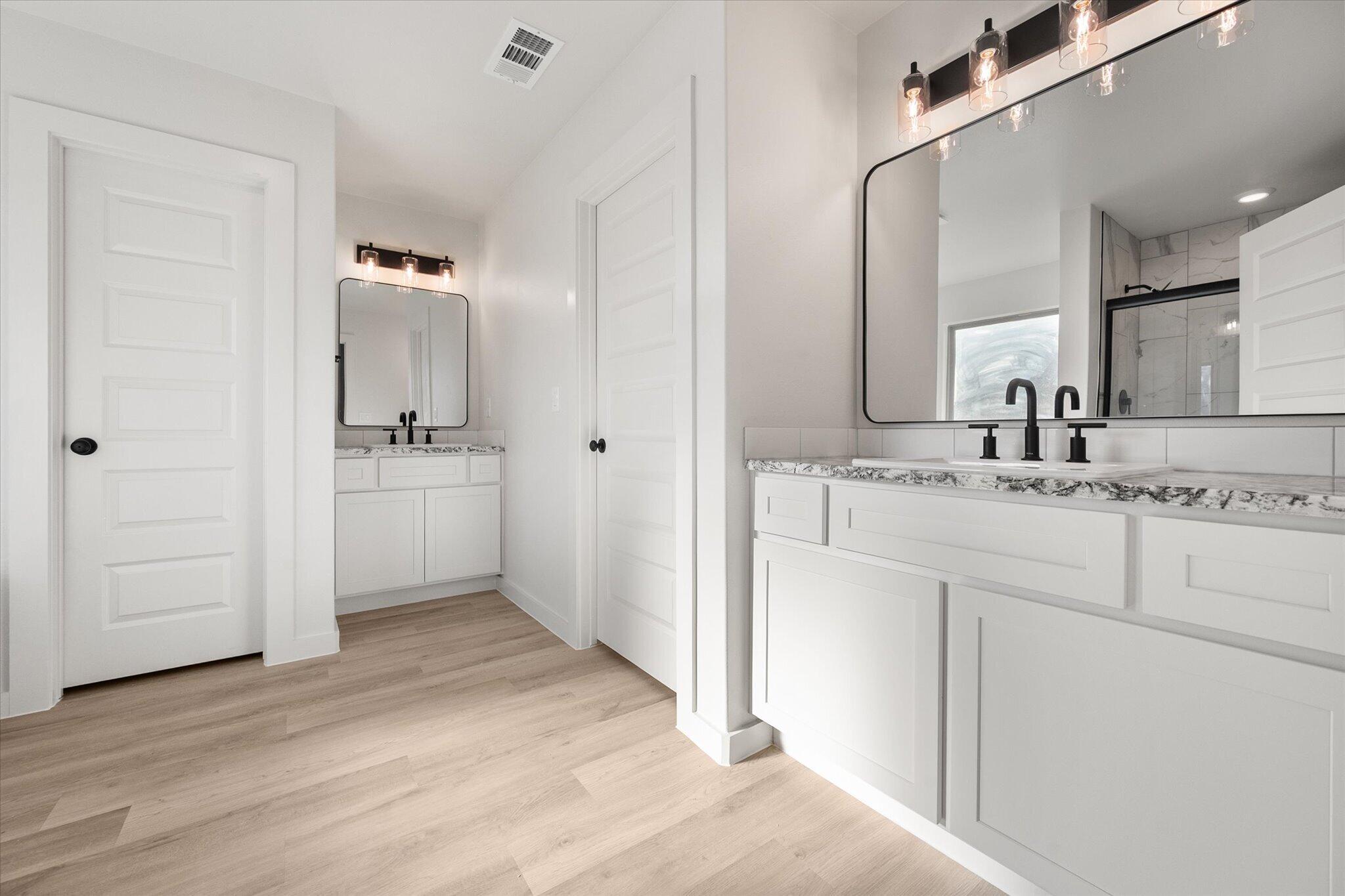6927 53rd Street Lubbock, TX 79407 - Photo 12 of 21 a bathroom with a sink and a mirror