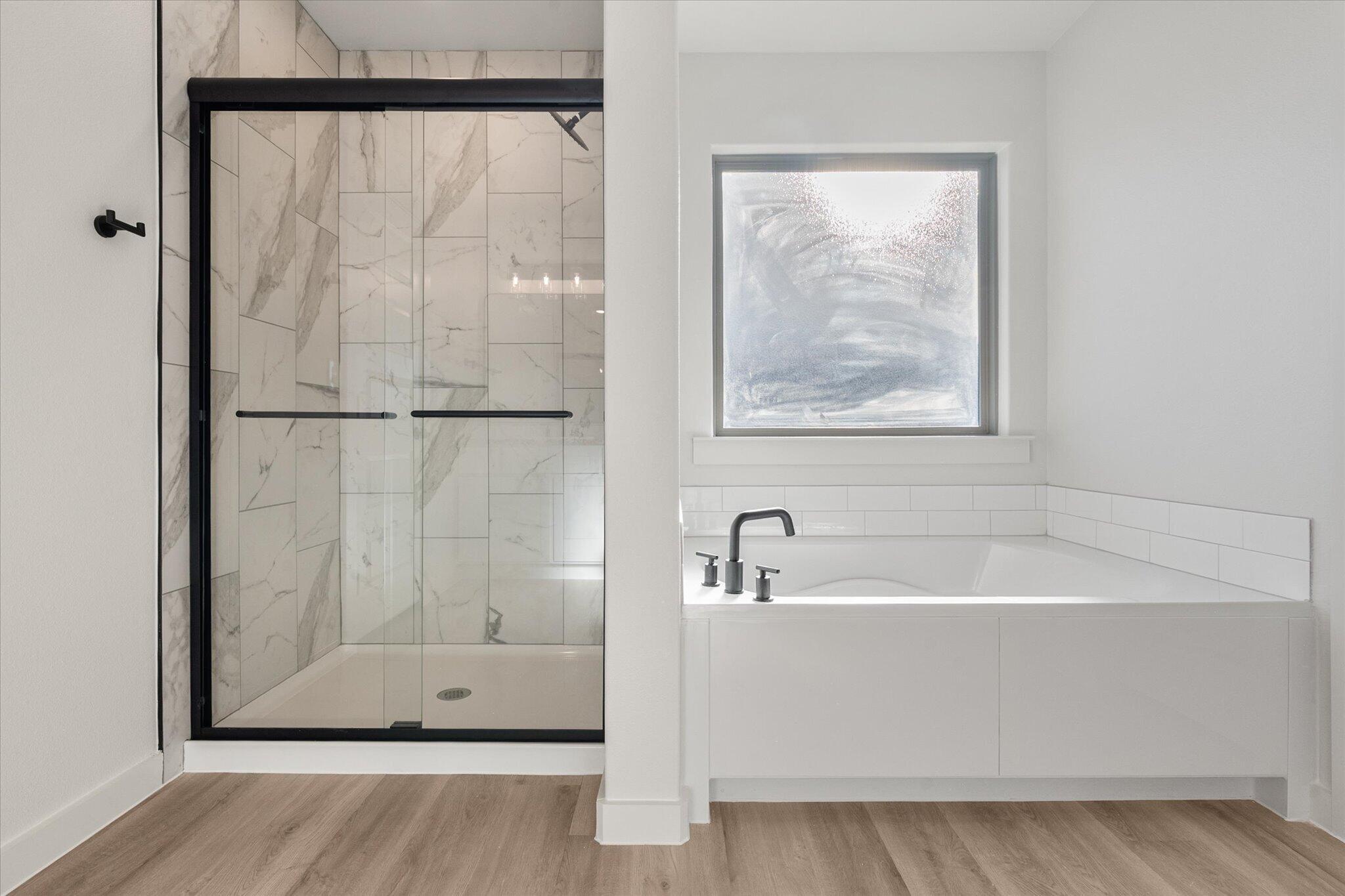 6927 53rd Street Lubbock, TX 79407 - Photo 14 of 21 a white bath tub sitting next to a shower