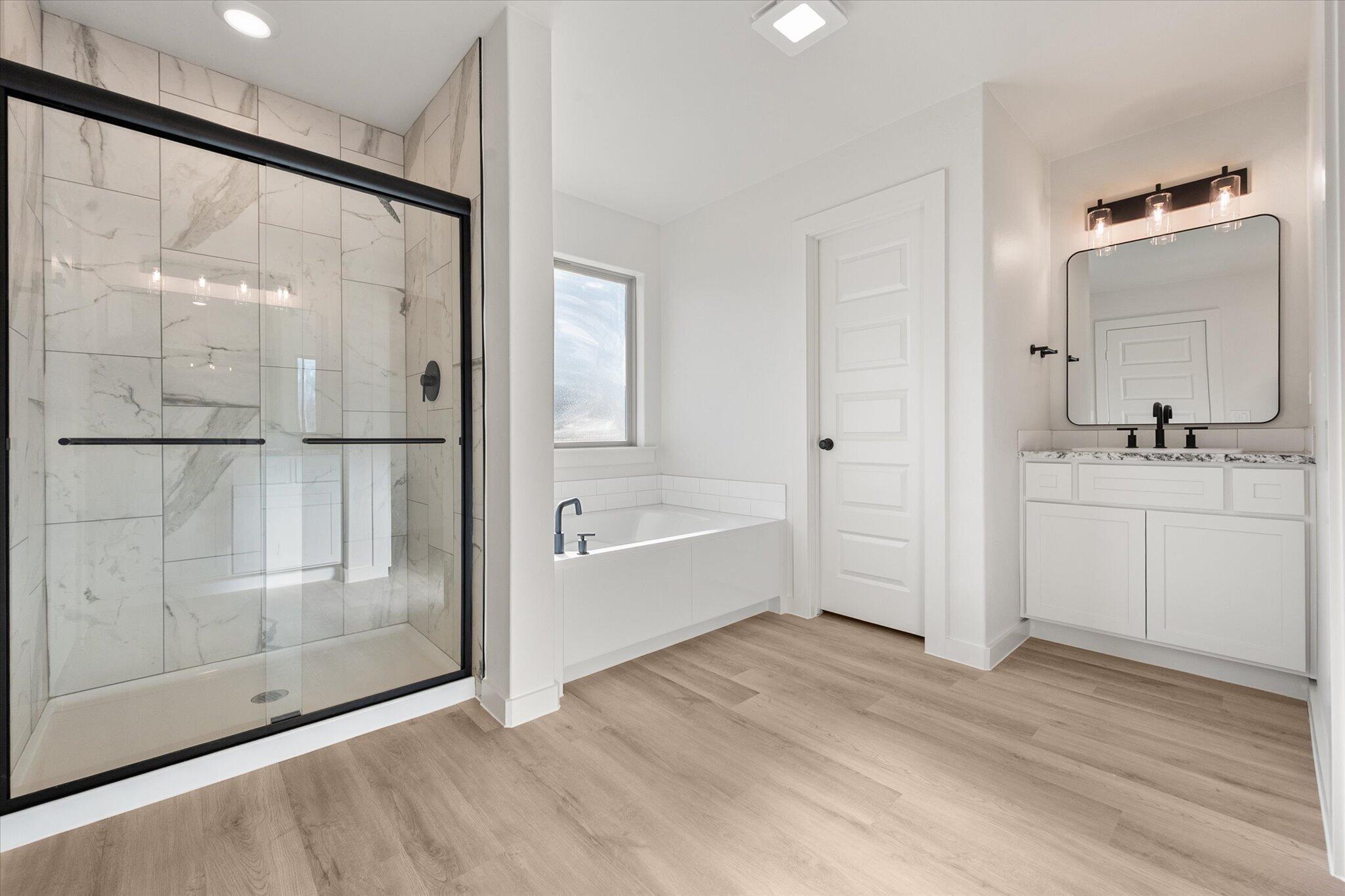 6927 53rd Street Lubbock, TX 79407 - Photo 15 of 21 a bathroom with a bathtub and a sink