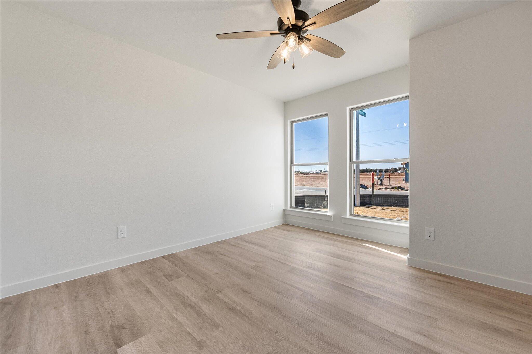 6927 53rd Street Lubbock, TX 79407 - Photo 18 of 21 wooden floor in an empty room with a window