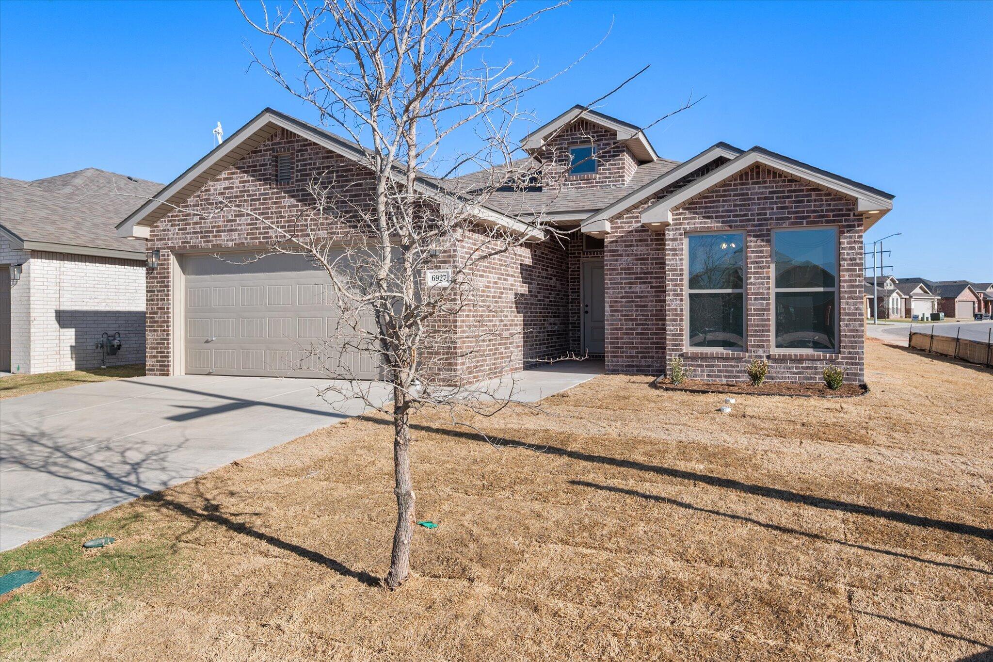 6927 53rd Street Lubbock, TX 79407 - Photo 2 of 21 a view of a house with a snow on the road