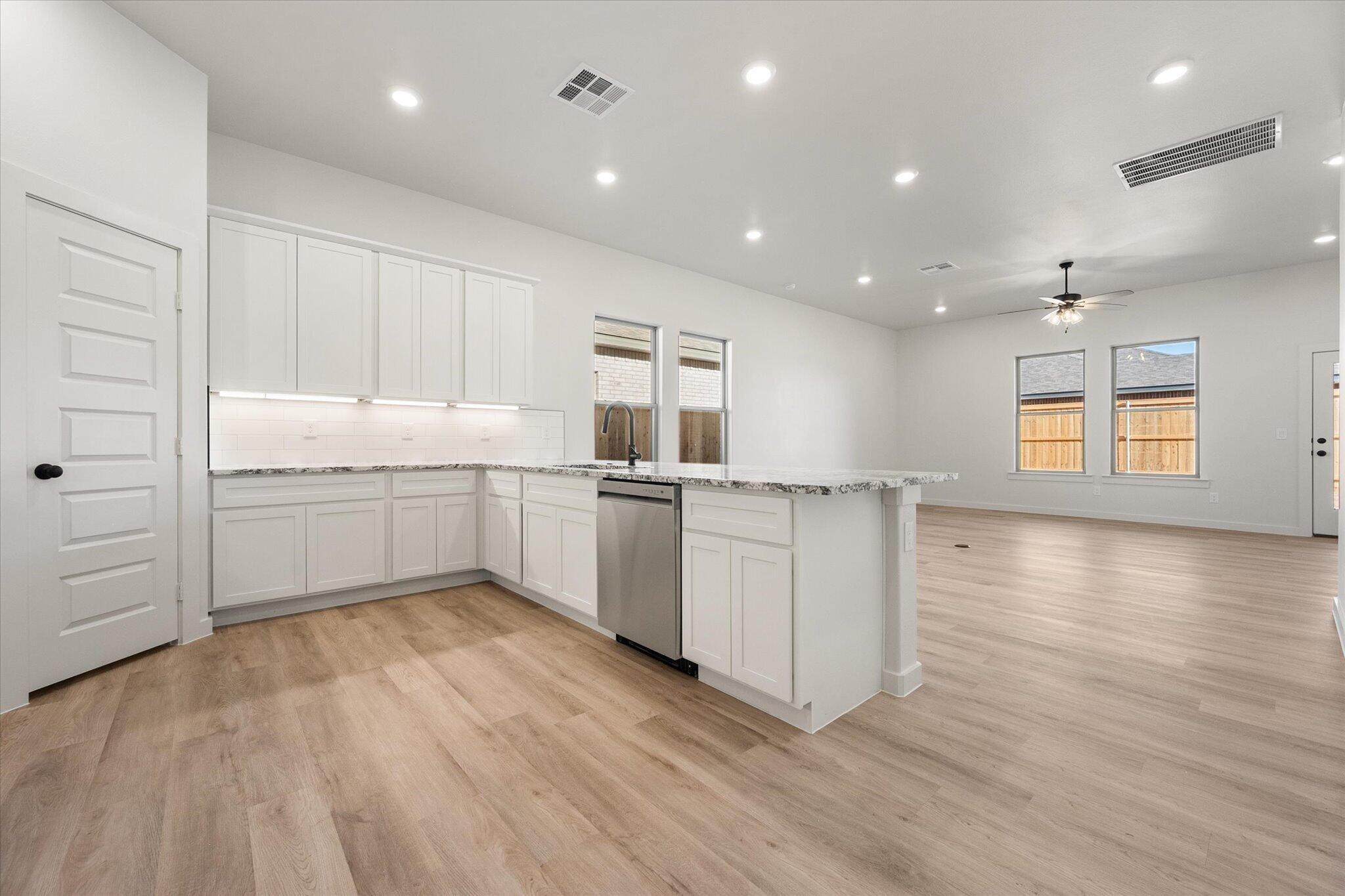 6927 53rd Street Lubbock, TX 79407 - Photo 7 of 21 a kitchen with a sink wooden floor and window
