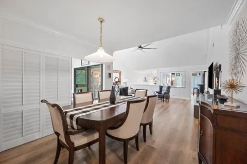 a dining room with furniture window and wooden floor