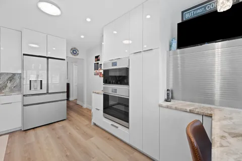 a kitchen with stainless steel appliances kitchen island granite countertop a stove a sink and a microwave