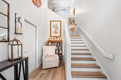 a view of entryway and hall with wooden floor