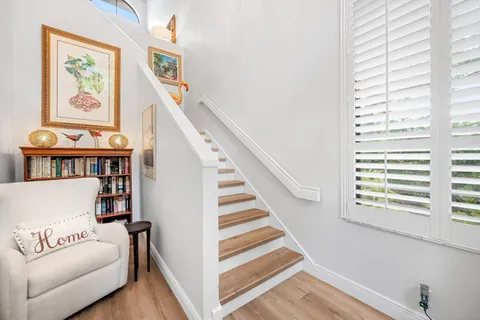 a living room with furniture and stairs