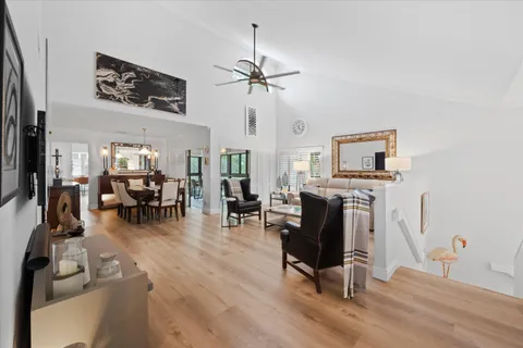 a living room with furniture a fireplace and wooden floor