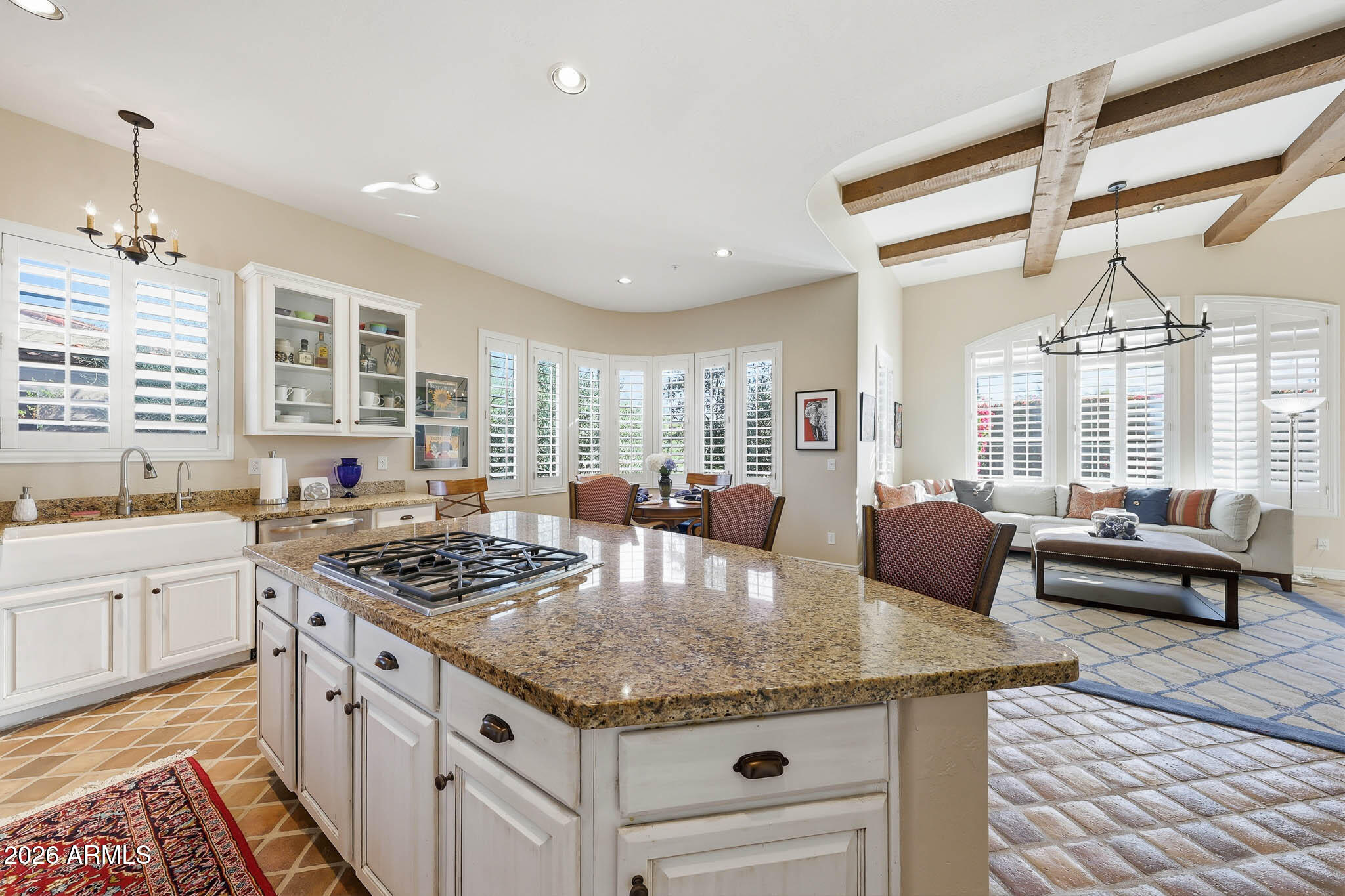 8891 East Mountain Spring Road Scottsdale, AZ 85255 - Photo 11 of 33 a kitchen with stainless steel appliances granite countertop a stove and a view of living room