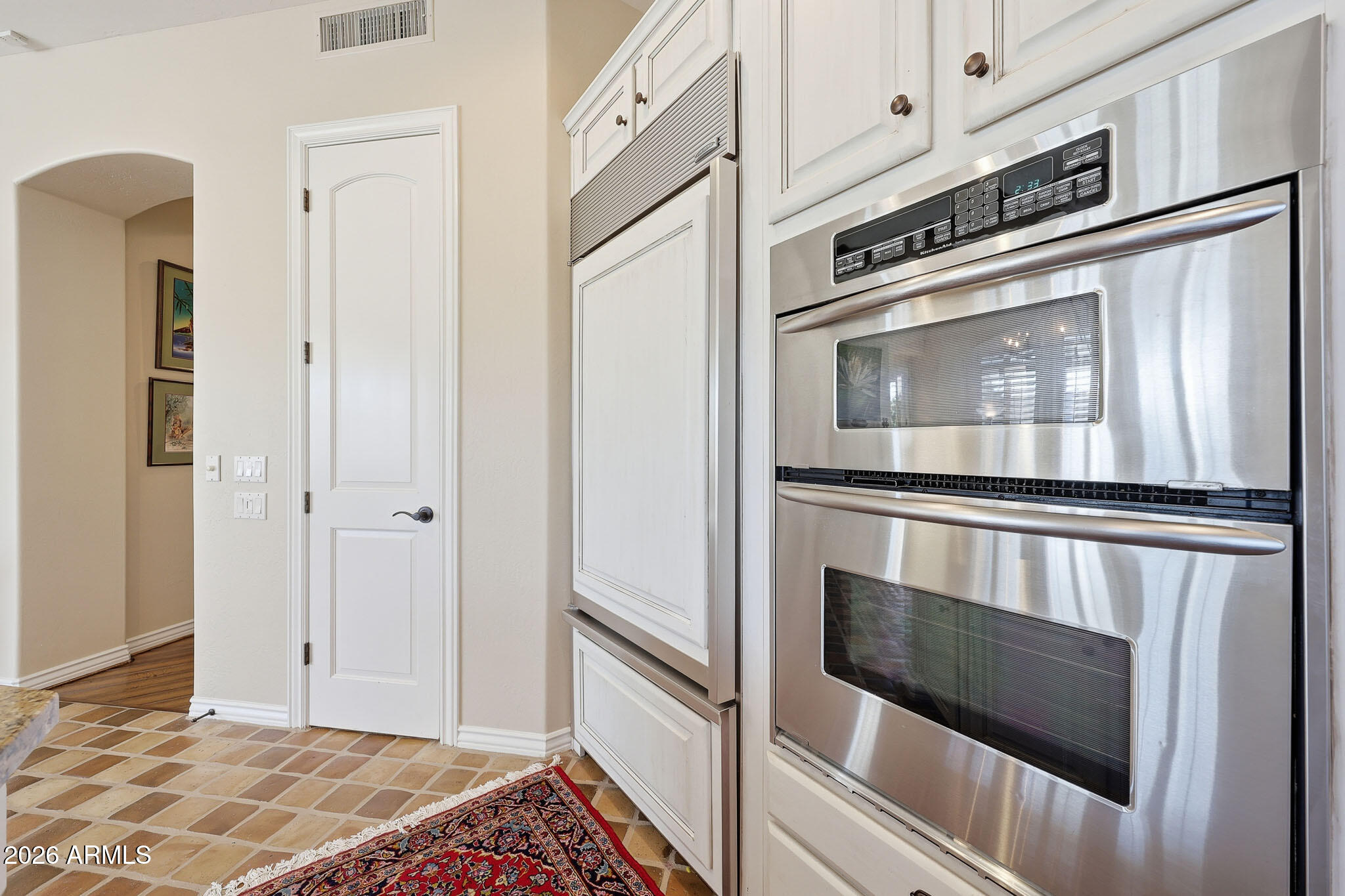 8891 East Mountain Spring Road Scottsdale, AZ 85255 - Photo 14 of 33 a kitchen with stainless steel appliances white cabinets and a stove