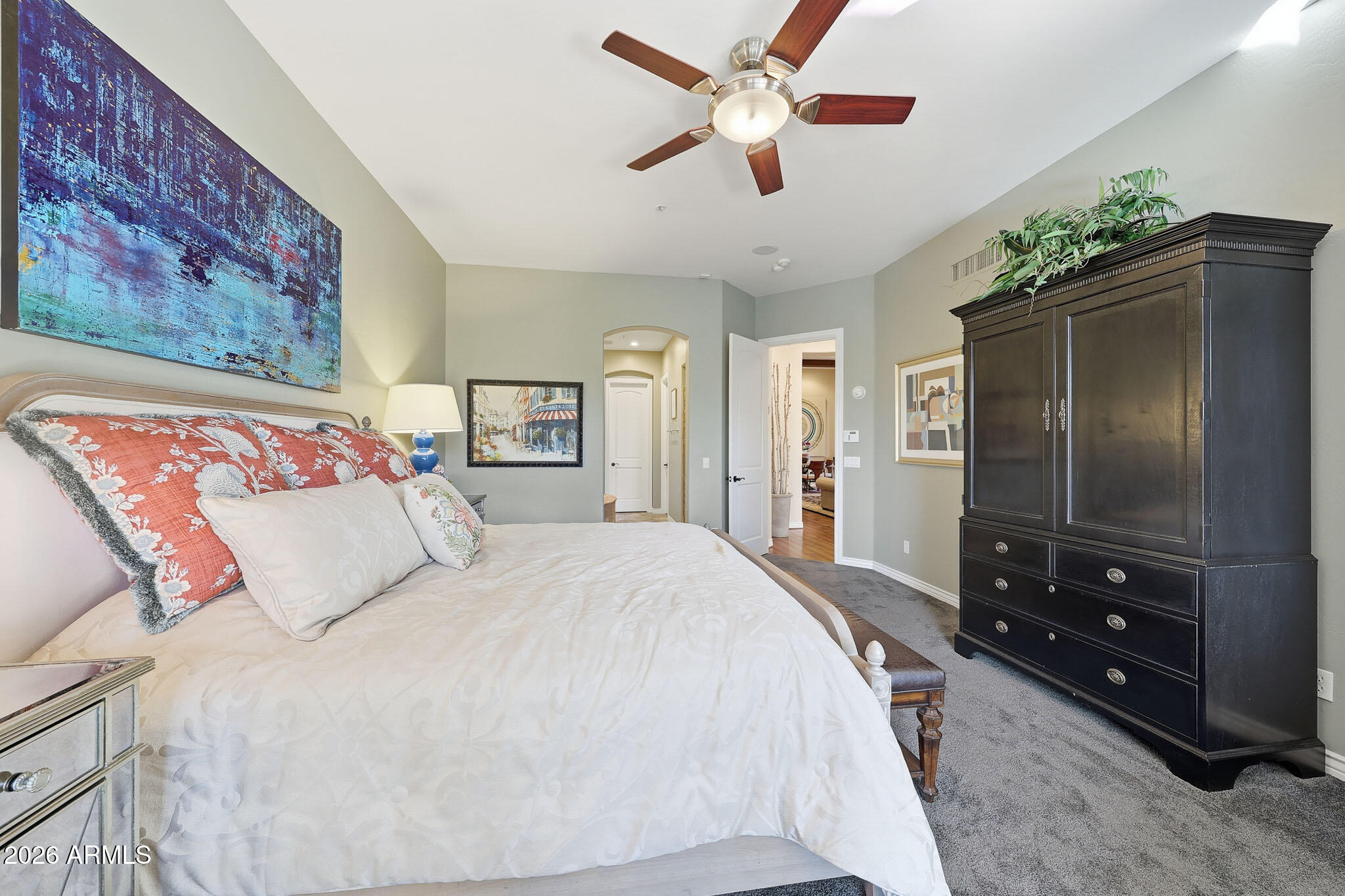8891 East Mountain Spring Road Scottsdale, AZ 85255 - Photo 18 of 33 a bedroom with a large bed and a chandelier