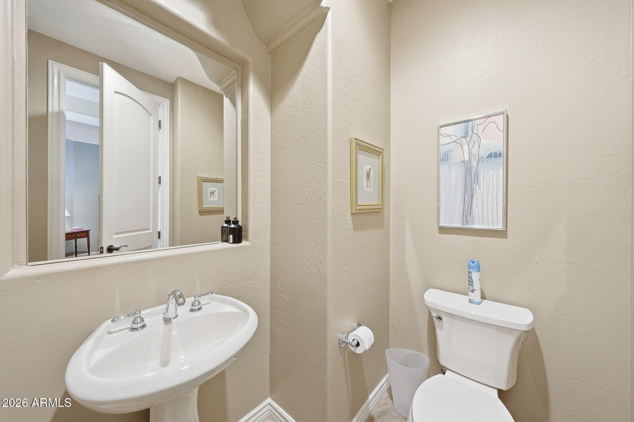 8891 East Mountain Spring Road Scottsdale, AZ 85255 - Photo 25 of 33 a bathroom with a toilet sink and mirror