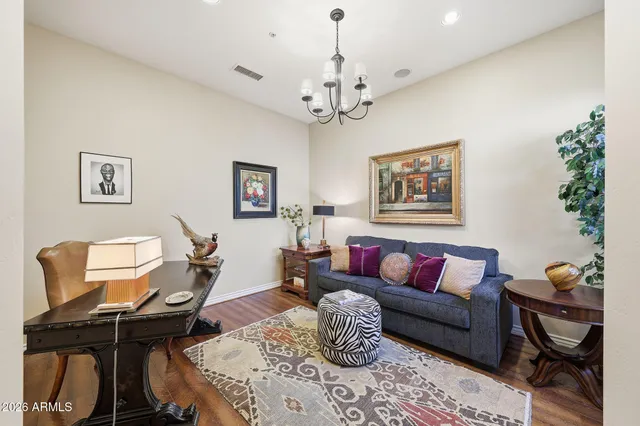 a living room with furniture a chandelier and a window