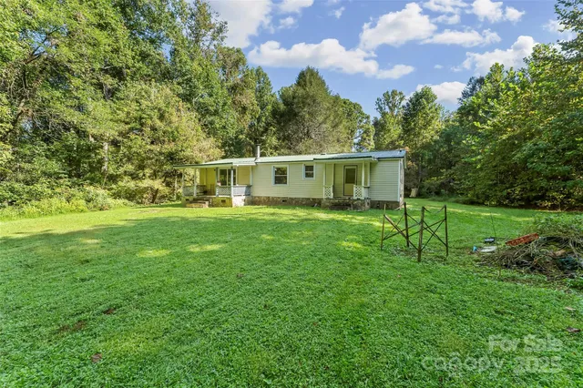 a view of a house with a backyard