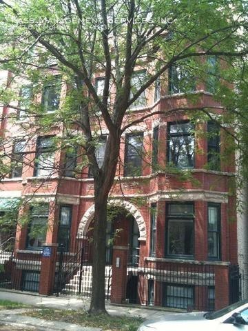 a view of a house with a tree in front of it