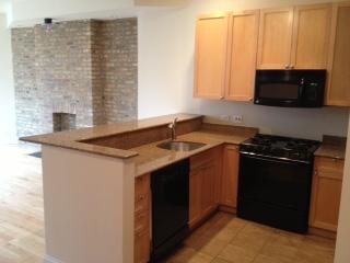 1418 North Mohawk Street, Unit 3S Chicago, IL 60610 - Photo 6 of 15 a kitchen with stainless steel appliances granite countertop a sink and a microwave