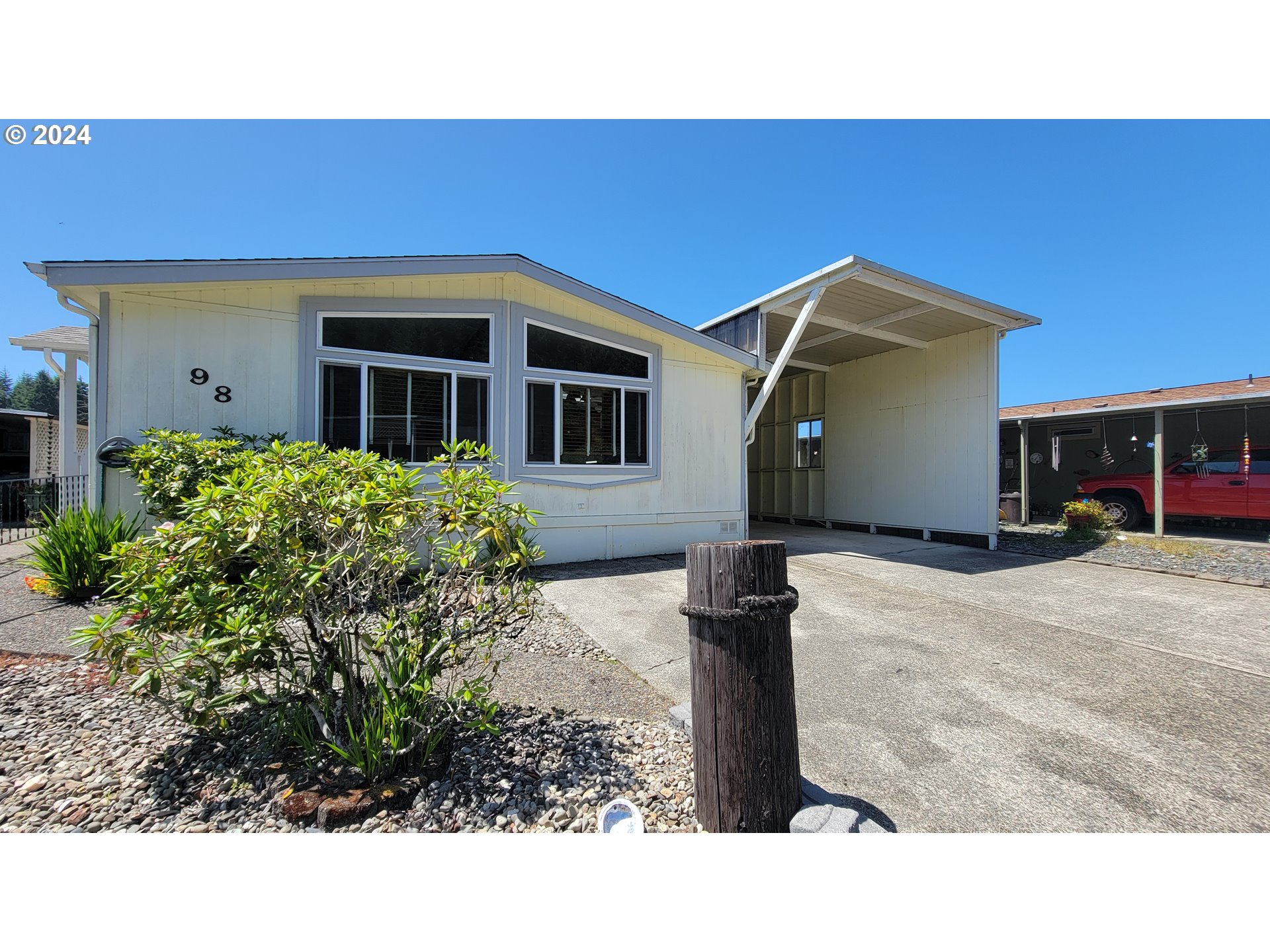 100 River Bend Road, Unit 98 Reedsport, OR 97467 - Photo 1 of 27 a view of a house with a backyard