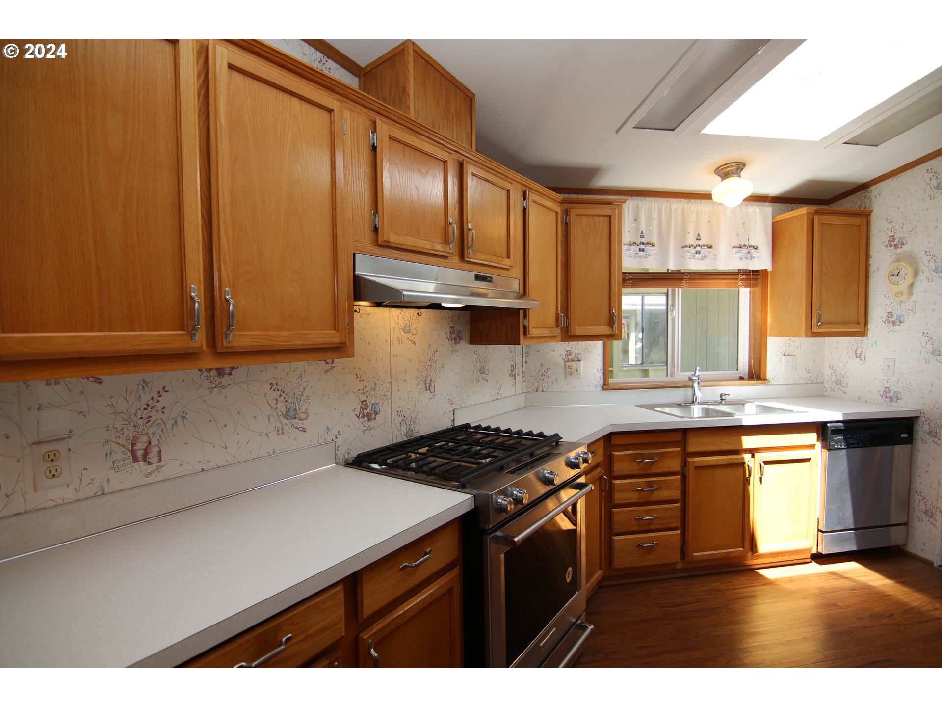 100 River Bend Road, Unit 98 Reedsport, OR 97467 - Photo 5 of 27 a kitchen with stainless steel appliances granite countertop a sink stove and cabinets