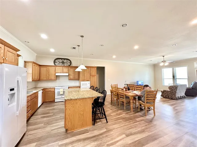 a large kitchen with a table and chairs in it