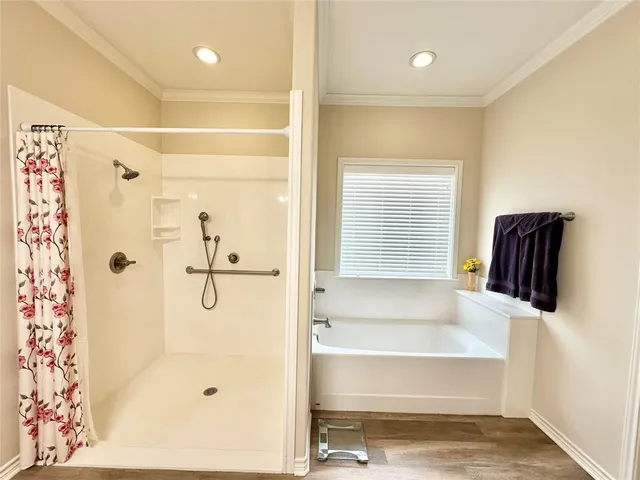 a bathroom with a bathtub and a shower