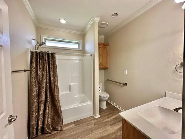 a bathroom with a sink a toilet and a shower