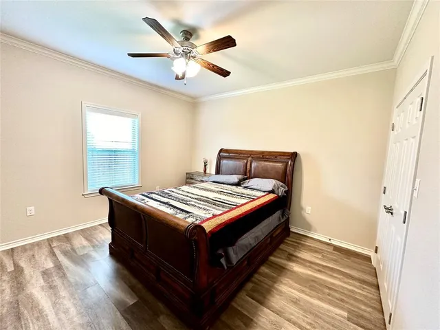 a bedroom with a bed and a chandelier