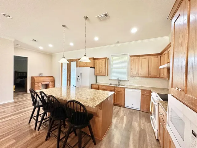 a large kitchen with a table and chairs in it