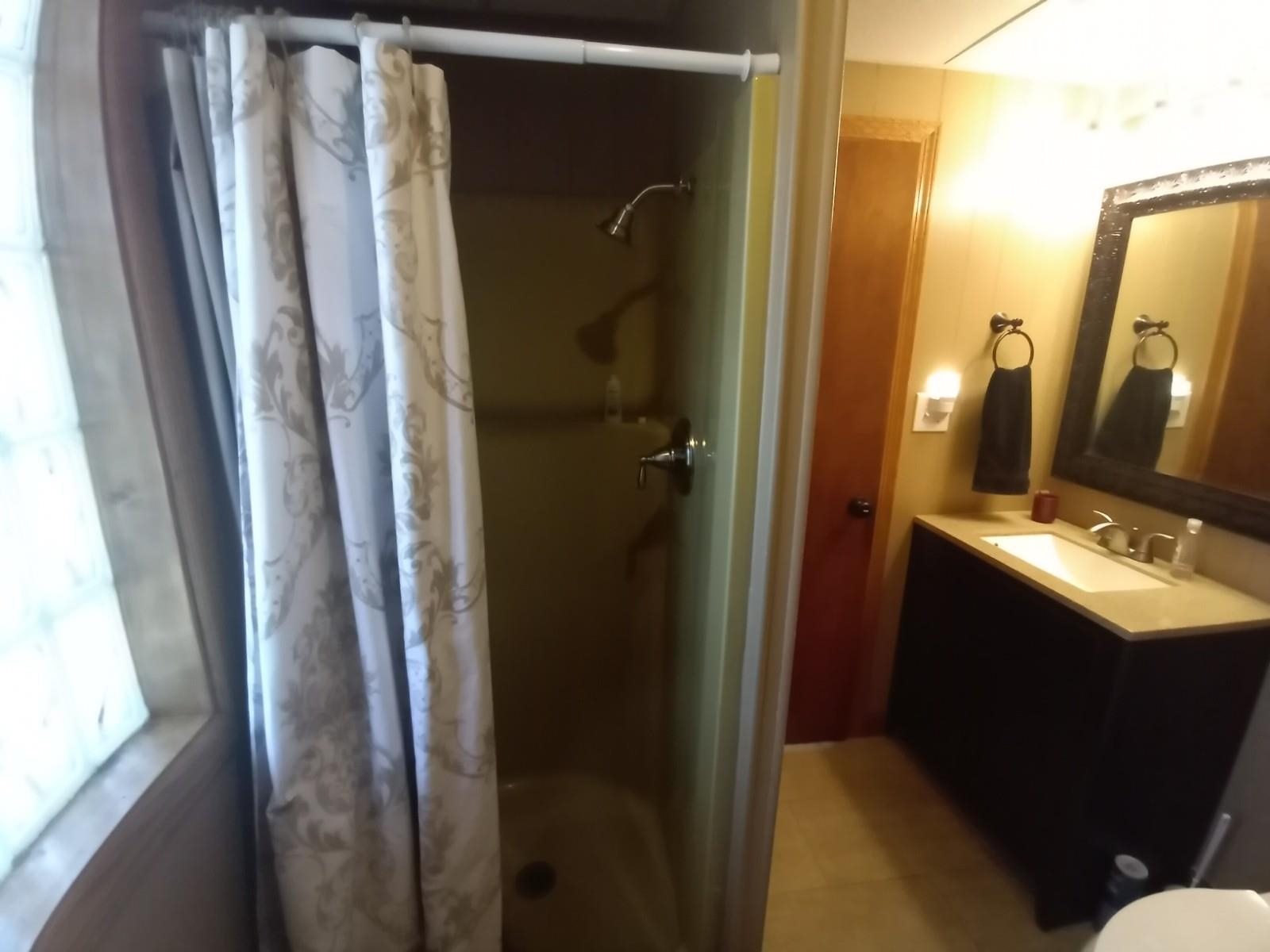 4115 Highcrest Road Rockford, IL 61107 - Photo 16 of 26 a bathroom with a sink and mirror with toilet