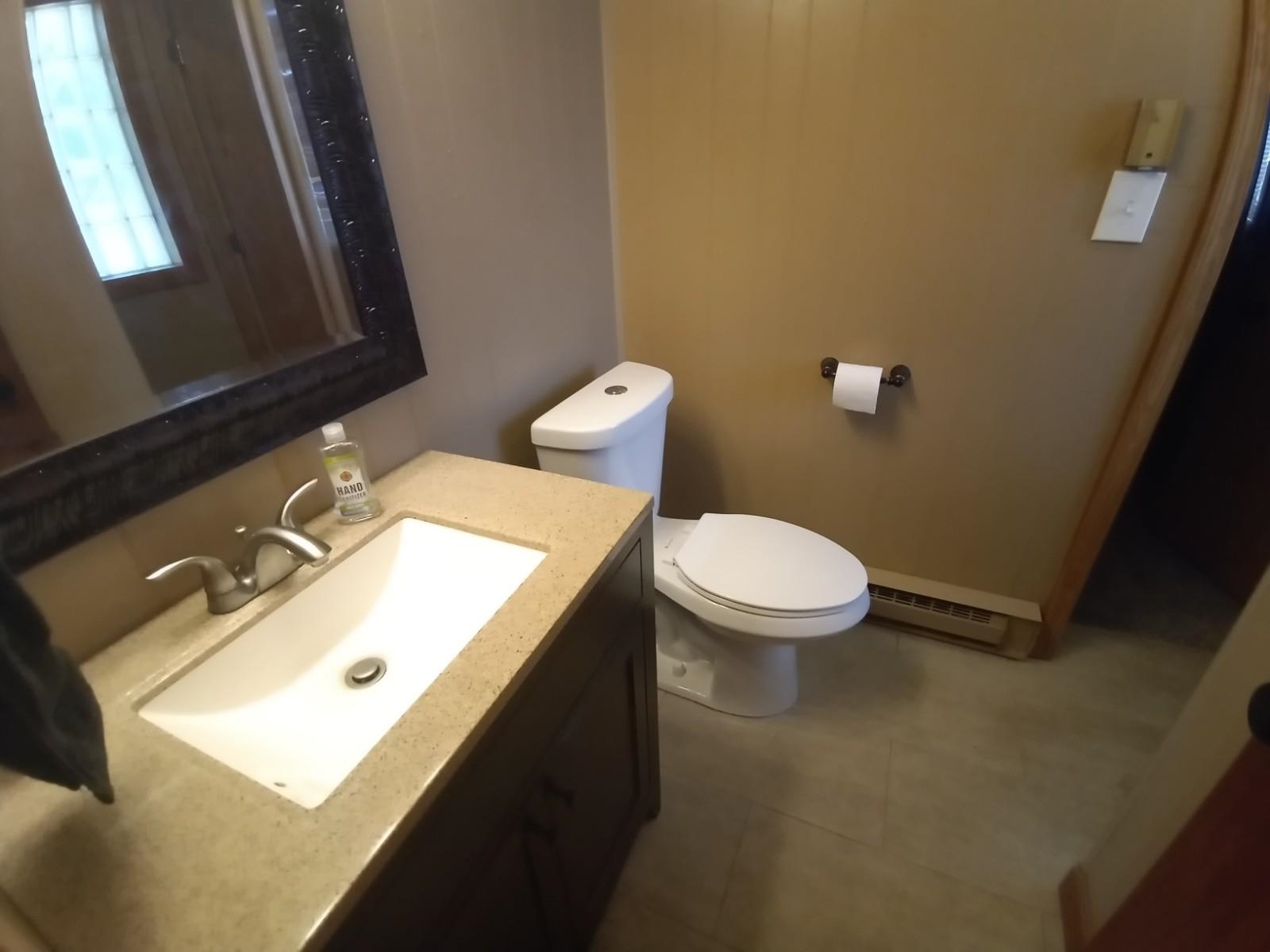 4115 Highcrest Road Rockford, IL 61107 - Photo 17 of 26 a bathroom with a sink mirror and toilet