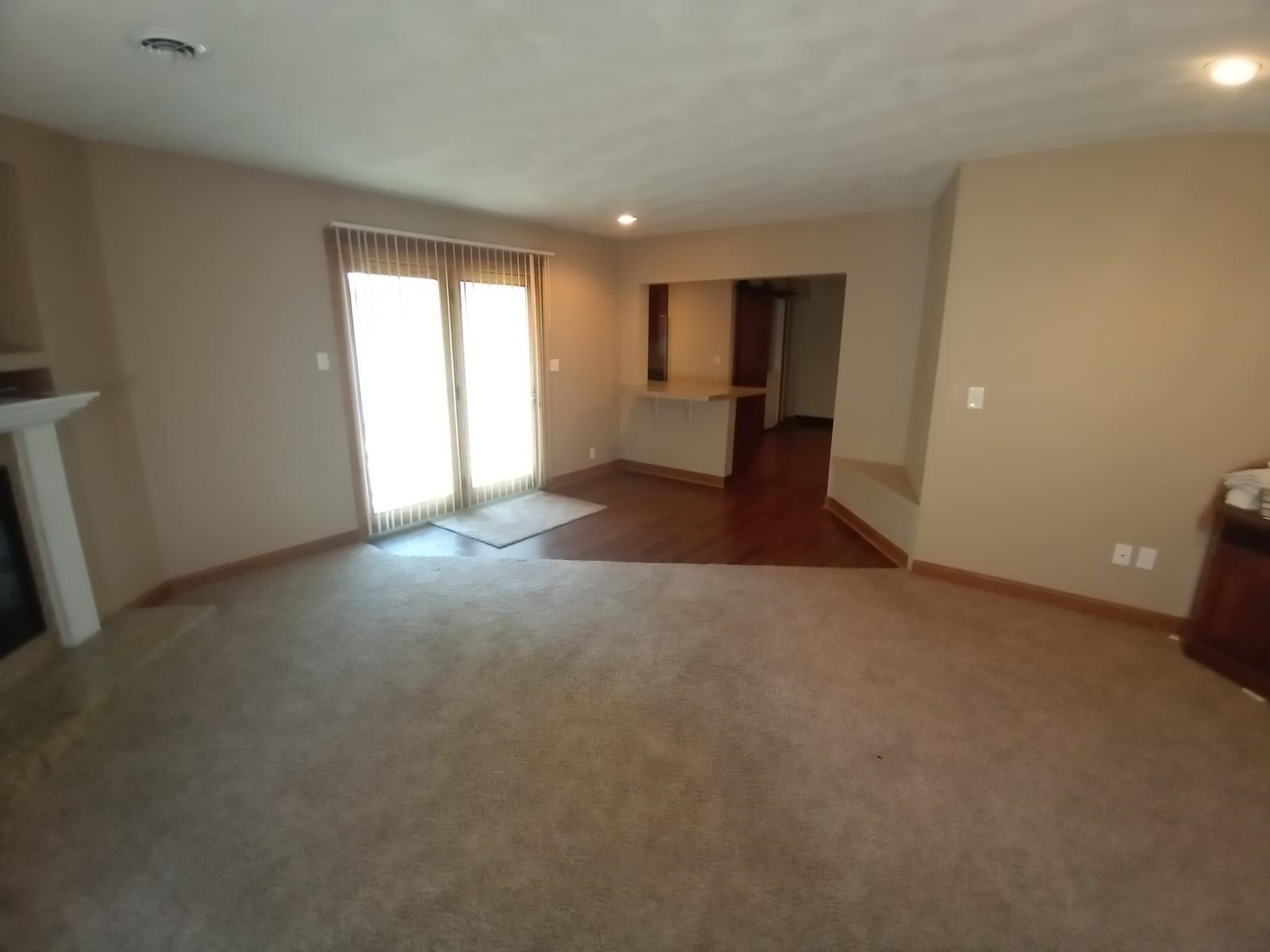 4115 Highcrest Road Rockford, IL 61107 - Photo 2 of 26 a view of empty room with wooden floor and fan