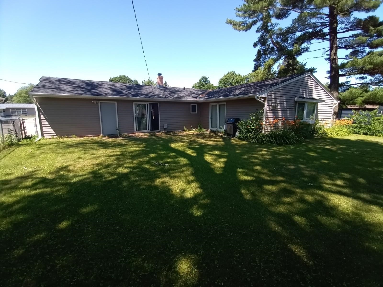 4115 Highcrest Road Rockford, IL 61107 - Photo 21 of 26 a view of a yard in front of a house with a large tree