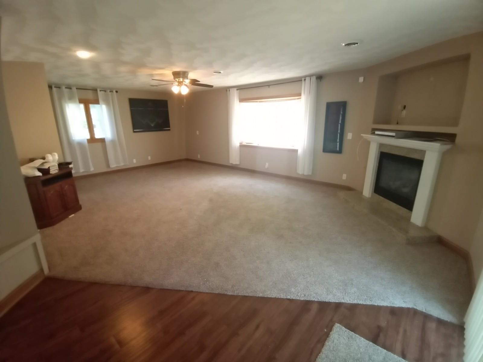 4115 Highcrest Road Rockford, IL 61107 - Photo 3 of 26 an empty room with windows and fireplace