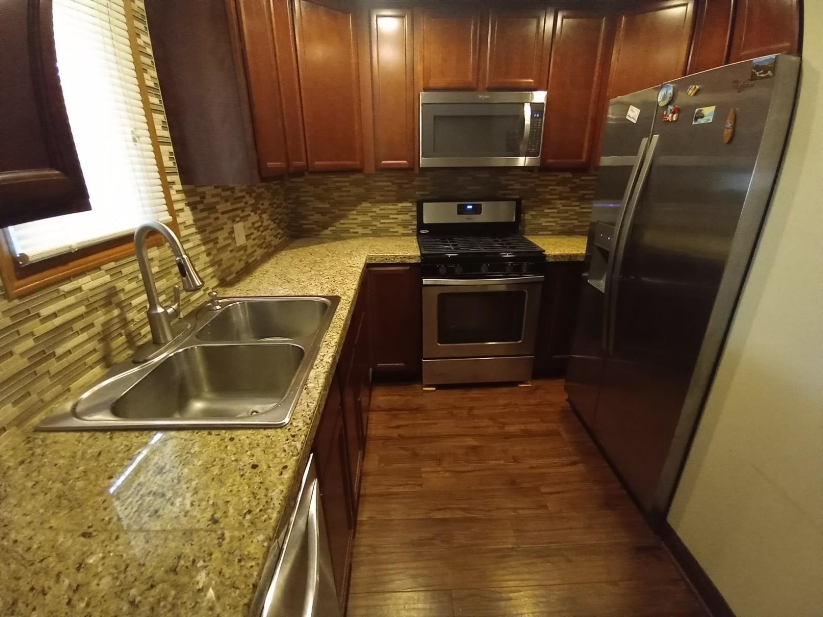 4115 Highcrest Road Rockford, IL 61107 - Photo 6 of 26 a kitchen with a sink and a stove top oven