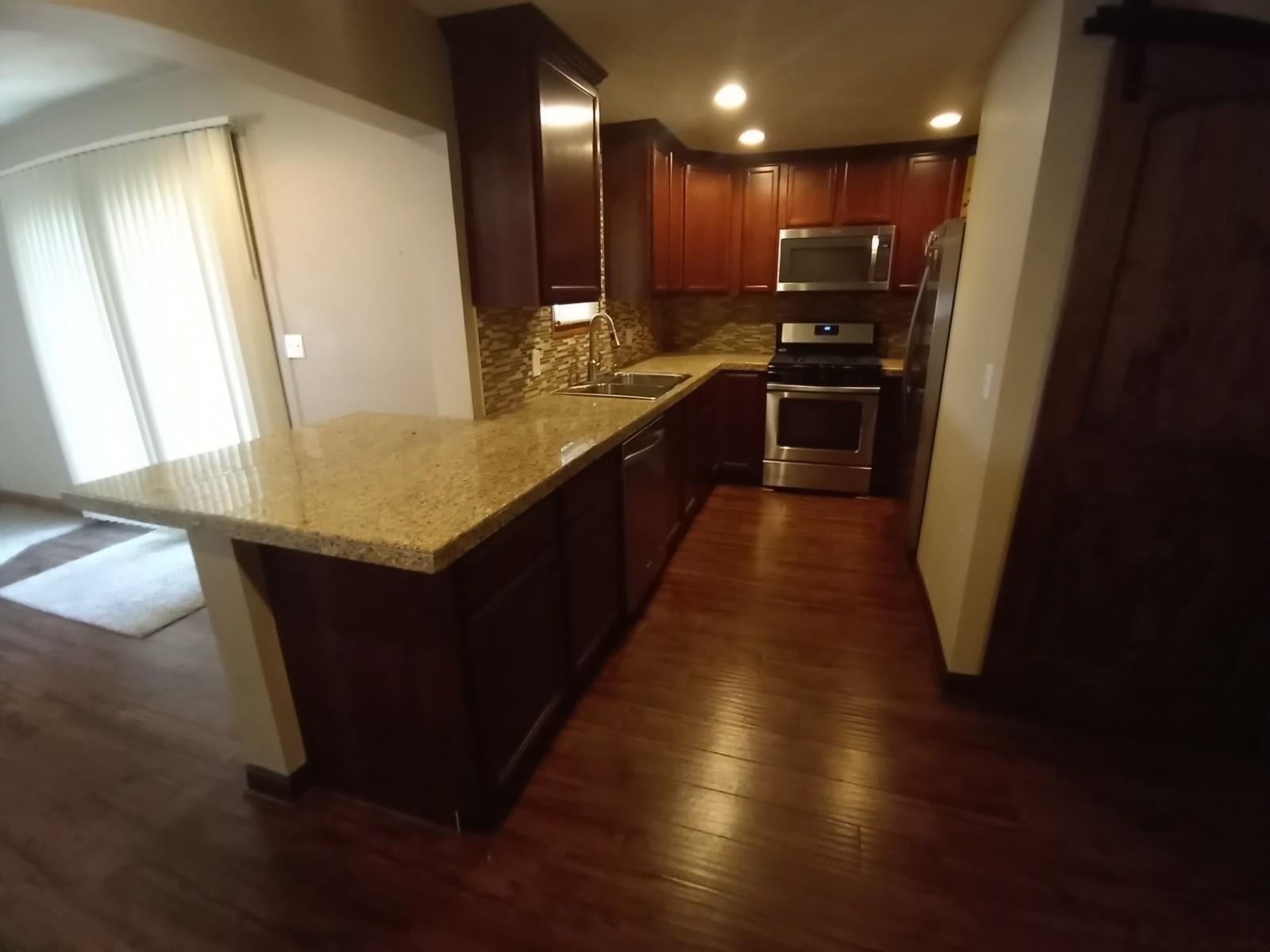 4115 Highcrest Road Rockford, IL 61107 - Photo 8 of 26 a large kitchen with stainless steel appliances a large counter top